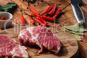 Two steak with chili and other condiment