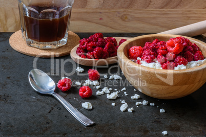 Cottage cheese with raspberries and cup of coffee for breakfast