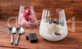 Sweet desert with ice cream, chocolate and berries in glass