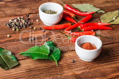 Different condiment in bowls or scattered on kitchen table.
