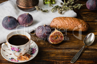 Cup of coffee with fresh bun and some figs