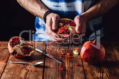 Opened Pomegranate in the Hands.