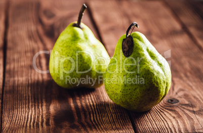 Two Pear on Wooden Background.