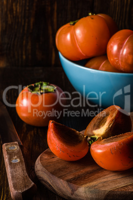 Persimmons on Wooden Background