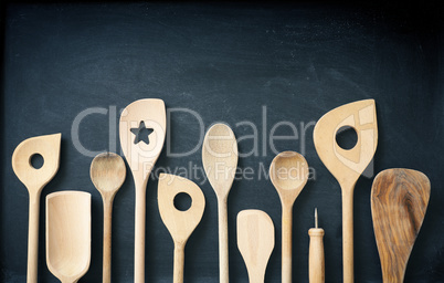 Wooden kitchen tools on a chalkboard