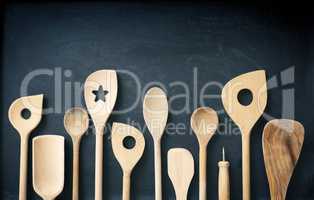 Wooden kitchen tools on a chalkboard