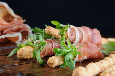 Grissini with prosciutto and arugula