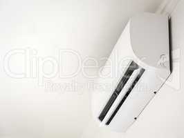 Close up white air conditioner swing mounted on a white wall
