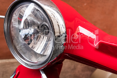 Classic round light of a Vespa scooter.