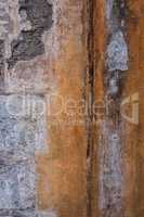 Vertical image of worn concrete wall.
