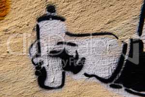Graffiti spray can painted on a concrete wall.