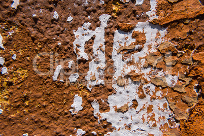 White stain on an old worn concrete orange wall.