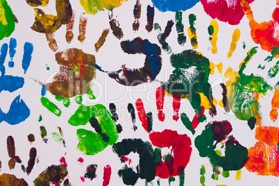 Detail of colorful handprints on a wall.