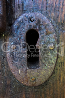 Ancient keyhole of a vintage wood door.