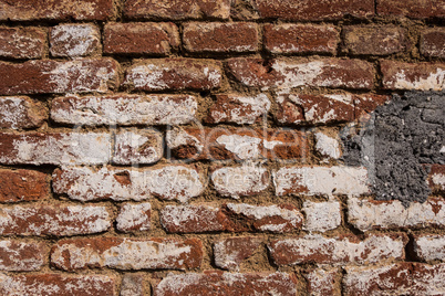Worn red brick with white paint wall texture.