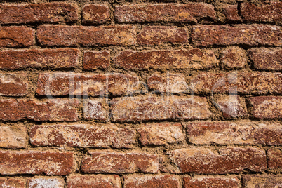 Old and worn red brick wall.