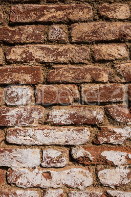 Old red brick wall with white stain.