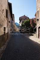 A medieval town alley with a Bougainvillea flower.