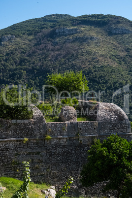 Medieval walls with mountains on the background.