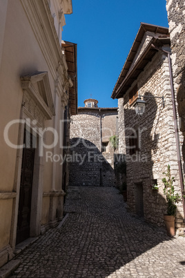 Shadows and plants in the street of a medieval town.