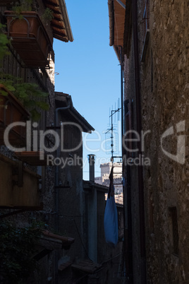 Shadowed alley with a castle on the background.