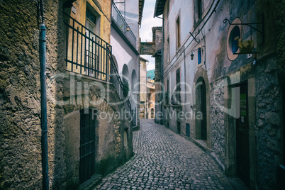 Mountain view on the background from the street of a medieval to