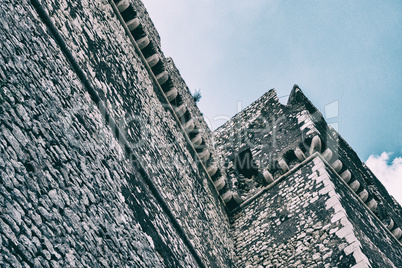 Low angle view of castle facade stone walls.