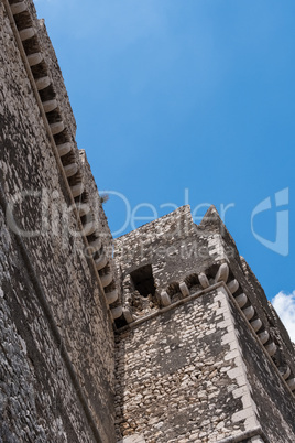 Caetani castle walls with blue sky in the background.