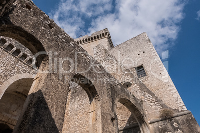 Arches of an ancient medieval castle with blue sky and clouds ba