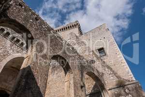 Arches of an ancient medieval castle with blue sky and clouds ba