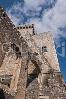 Arches of an stone old castle with blue sky and clouds backgroun