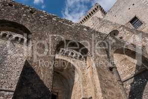 Arches of an old castle with blue sky and clouds background.