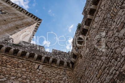 Abstract geometric design image of a castle with blue sky and cl
