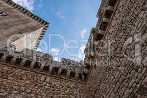 Abstract geometric design image of a castle with blue sky and cl