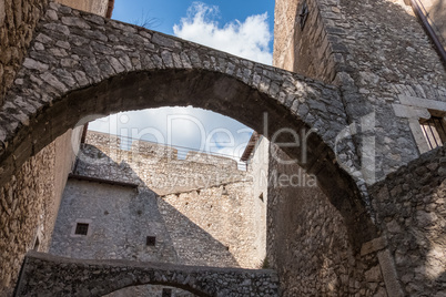 Low angle view of stone castle arches and walls from an inside c