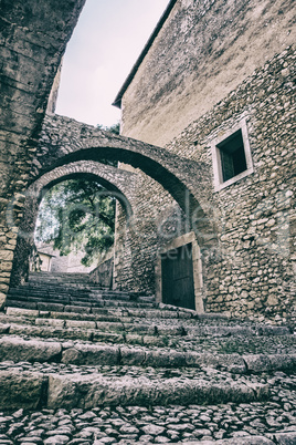 Vertical view of stairs and walls of a castle with white sky bac