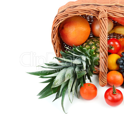 Vegetables and fruits in a basket isolated on white background.