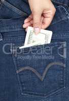 hand pulls out of the back pocket of blue jeans bill hundred do
