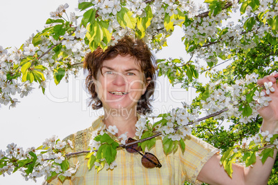 Woman on the tree with cherry blossoms