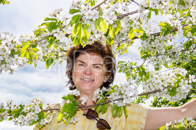 Woman on the tree with cherry blossoms