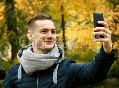 Cute young man with smartphone