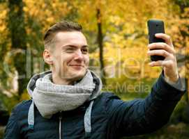 Cute young man with smartphone