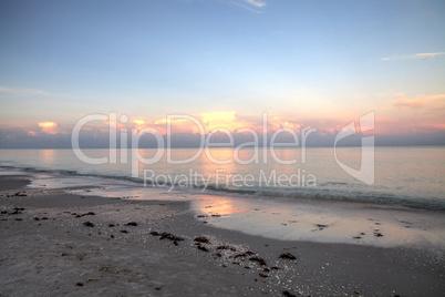 Pink sky over a calm ocean in Naples, Florida