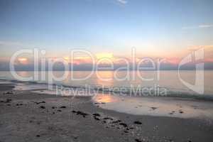 Pink sky over a calm ocean in Naples, Florida