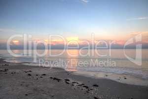 Pink sky over a calm ocean in Naples, Florida