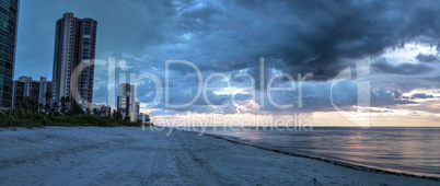 Rain pours from dark clouds over Clam Pass Beach in Naples, Flor