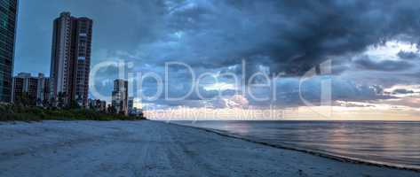 Rain pours from dark clouds over Clam Pass Beach in Naples, Flor