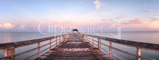 Early sunrise over the Naples Pier on the Gulf Coast of Naples,