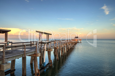 Early sunrise over the Naples Pier on the Gulf Coast of Naples,