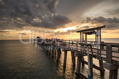 Pink and purple sunset over the Naples Pier on the Gulf Coast of